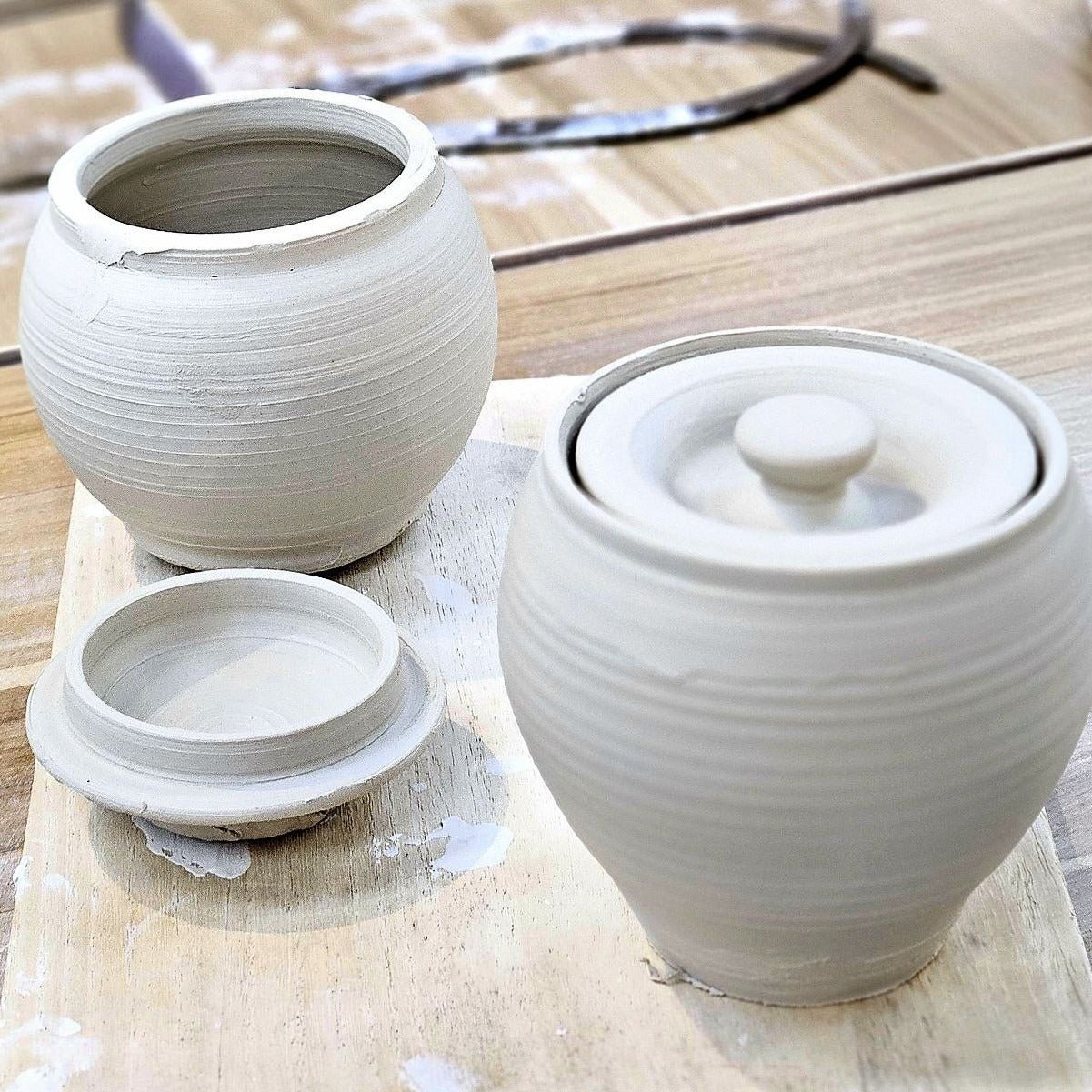 Close-up of formed lidded jar made on pottery wheel in advanced pottery class