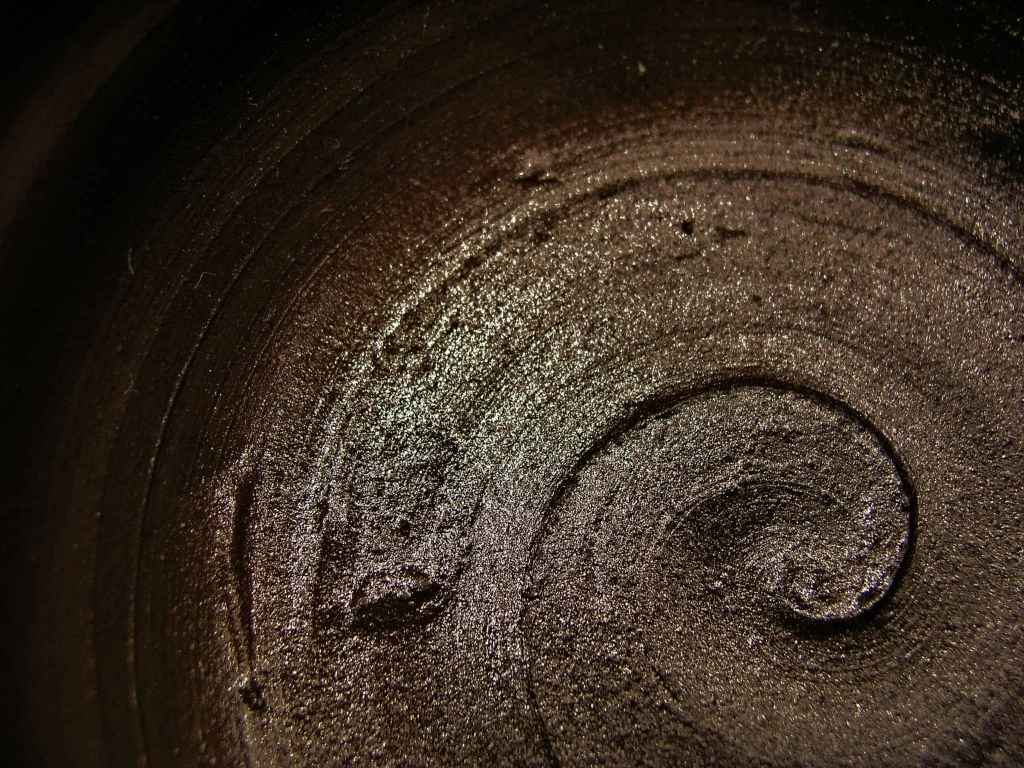 Close-up of dark clay spinning on a pottery wheel at Urth & Phire Ceramic Studio, Singapore's premier ceramic studio